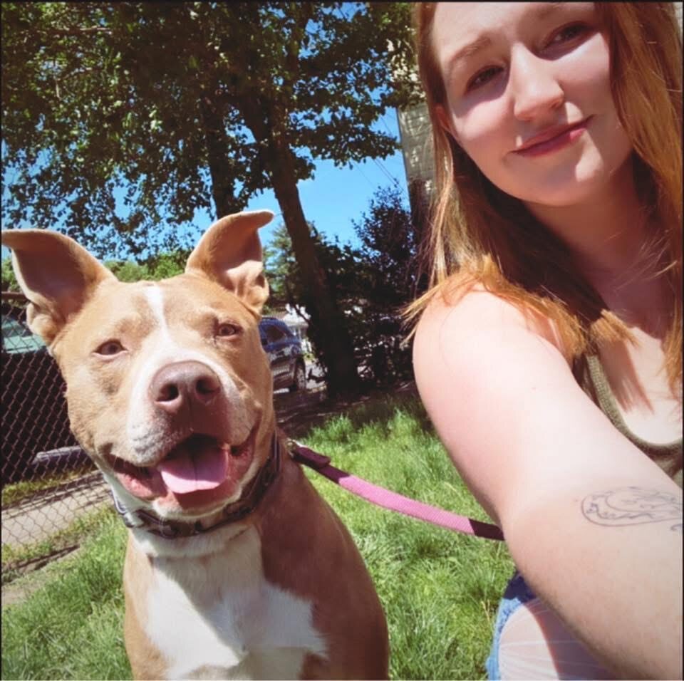 Devyn outdoors with a happy dog in her care